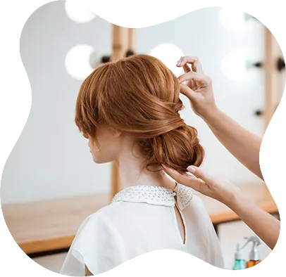 female hairdresser making hairstyle redhead woman beauty salon